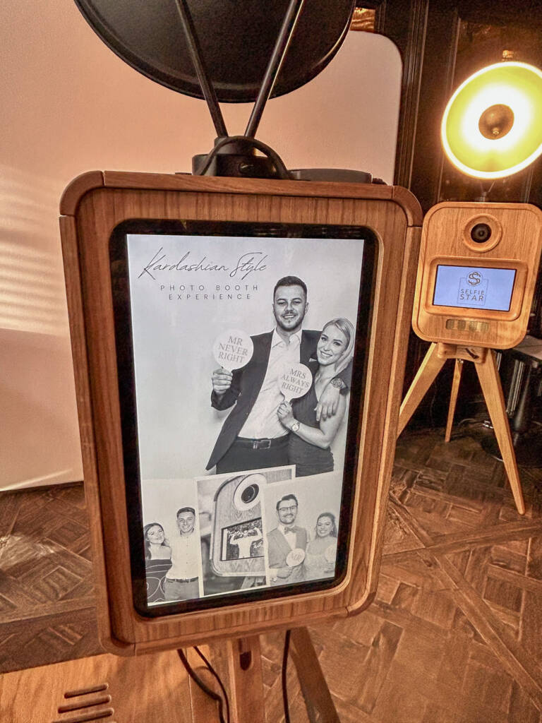 Luxury Oak Vintage Photo Booth by Selfie Star featuring "Kardashian Style" branding, displaying playful signs "Mr Never Right" and "Mrs Always Right", with guests enjoying the photo booth experience at the Wedding Showcase in Manor House Lindley.